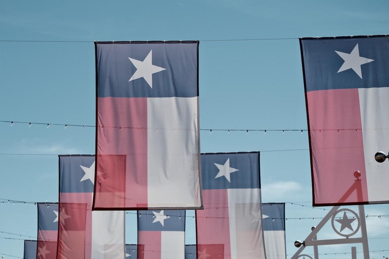 texas state flags - taxpayers in texas set to lose out on market for municipal green bonds